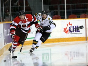 Ottawa 67's captain Travis Konecny fights off London Knights' defenceman Victor Mete during Friday night's game between the clubs at TD Place. 
CHRIS HOFLEY/OTTAWA SUN