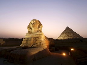 The sphinx is pictured near the pyramids of Menkaure and Khafre in Giza, during its reopening ceremony November 9, 2014. REUTERS/Mohamed Abd El Ghany