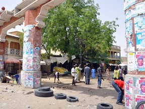 The main gate to the Monday Market is closed on March 7, 2015 after a blast in Maiduguri. Three bombings in northeast Nigeria's largest city of Maiduguri killed 58 people on March 7 and wounded 139 others, the area police chief said. Reports from the three locations indicate that 58 are dead, while 139 persons were injured," said Clement Adoda, police commissioner of Borno state, of which Maiduguri is the capital.  Many children were among the dead and at least 50 others were wounded in the explosions that hit two crowded markets and a busy bus station.  AFP PHOTO / PTUNJI OMIRIN
