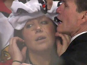 Chicago Blackhawks fan Alexis Bovard receives medical attention after being hit by a pane of glass Friday at the United Center. (Screengrab)