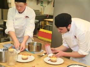 Jared Hartley and Keith Petrasek, of Prince Edward Collegiate Institute prepare their title winning dessert, during the 14th Iron Chef contest at Loyalist College