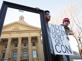 Protestors hold mirrors up to the Alberta Legislature during a protest in response to Premier Jim Prentice's comments suggestion that Albertans look in the mirror to see who is to blame for the Province's current economic crisis, in Edmonton Alta., on Saturday March 7, 2015. David Bloom/Edmonton Sun/QMI Agency