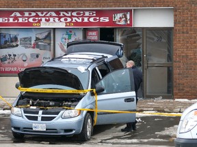 A man was killed when a minivan backed up into him and crushed him against this Brampton store front on March 7, 2015. (Pascal Marchand photo/Special to the Toronto Sun)