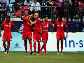 Toronto FC celebrates after scoring against Vancouver at BC Place on Saturday. (USA TODAY SPORTS)