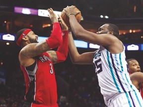 Raptors’ James Johnson blocks Hornets’ Al Jefferson during Friday’s game in Charlotte. Toronto needs more defence like this to have nay hope of a playoff run. (USA TODAY SPORTS)