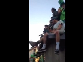 A video posted on YouTube shows people sitting on rooftops during a St. Patrick's Day party attended by students from California Polytechnic University in San Luis Obispo, California, March. 7, 2015. A garage roof packed with party-goers collapsed injuring eight people. (YouTube screengrab)