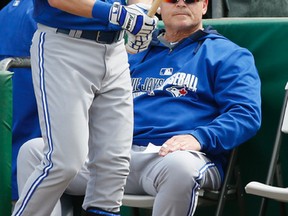 Manager John Gibbons takes in Saturday’s game at Clearwater against the Phillies from his seat at the edge of the dugout steps. (STAN BEHAL/TORONTO SUN)