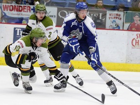 North Bay Battalion Ray Huether tries to block a shot from Sudbury Wolves Chad Heffernan during OHL action from the Sudbury Community Arena on Saturday night. Gino Donato/The Sudbury Star