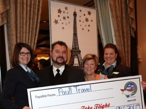 Kyle Chrystian, President of Dreams Take Flight, accepts a $15,700 cheque from Lesley Paull (second from right) of Paull Travel at last night’s Air Canada-sponsored Gala. (TREVOR SCHNEIDER/SUPPLIED)