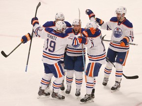 Mar 6, 2015; Chicago, IL, USA; Edmonton Oilers center Derek Roy (8) celebrates with teammates after scoring a goal against the Chicago Blackhawks during the first period of an NHL game at United Center. Mandatory Credit: Kamil Krzaczynski-USA TODAY Sports
