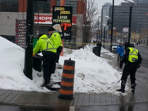 Ottawa Police Emergency Services Unit search for a weapon after a shooting took place near Rideau St. and King Edward Ave. around 5:30 a.m. Sunday, March 9, 2015. Three men have been taken into custody and the victim, who was shot at, wasn't injured.  
(Keaton Robbins/Ottawa Sun)