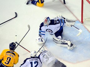 Winnipeg Jets goalie Michael Hutchinson (34) makes a save during the third period against the Nashville Predators at Bridgestone Arena. The Jets won 3-1. (Christopher Hanewinckel-USA TODAY Sports)