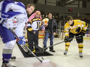 The Iron Sheik drops the puck during a ceremonial faceoff before the Kingston Frontenacs game on Feb. 27 at the Rogers K-Rock Centre along with his longtime family friend and agent Page Magen. (Julia McKay/The Whig-Standard)