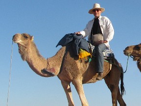 Columnist Mike Strobel on a camel.
