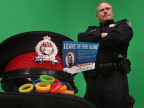 Sergeant Denis Hull from the Ottawa Police Service poses for a photo in Ottawa Ont. Friday March 6, 2015. The Ottawa Police are starting a campaign called "Leave The Phone Alone" which urges drivers to stop using their phones while driving. (Tony Caldwell/Ottawa Sun/QMI Agency)