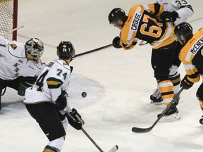 Kingston Frontenacs' Lawson Crouse takes a swipe at a rolling puck in front of London Knights goaltender Tyler Parsons during the second period of Ontario Hockey League action at the Rogers K-Rock Centre on Sunday. The Fronts won 4-3.  (Julia McKay/The Whig-Standard)