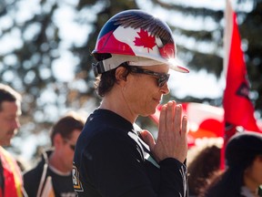 Denise Nadeau takes part in a prayer during the start of the International Women's Day march at the University of Alberta, in Edmonton Alta., on Sunday March 8, 2015. David Bloom/Edmonton Sun/QMI Agency