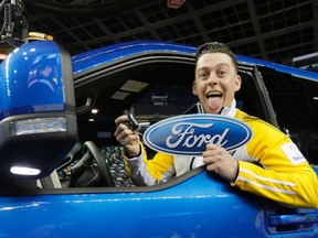 Team Manitoba's Colin Hodgson cheers as he's presented with the keys to a Ford truck by Ford's Gerald Wood final shot at the Ford Hot Shots competition at the 2015 Tim Horton's Brier in Calgary, Alta., on Saturday February 28, 2015. He was the eventual winner over Team Saskatchewan's Dallan Muyres. Mike Drew/Calgary Sun/QMI Agency