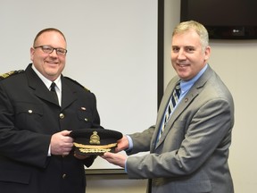 New bylaw Chief Roger Chapman (left) receives his epaulettes from paramedic Chief Anthony Di Monte (right). 
(Supplied by City of Ottawa/OTTAWA SUN/QMI Agency)