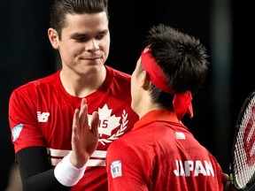 Canada's Milos Raonic congratulates Japan's Kei Nishikori following their Davis Cup match at the Doug Mitchell Thunderbird Sports Centre in Vancouver March 8, 2015. (REUTERS/Kevin Light)