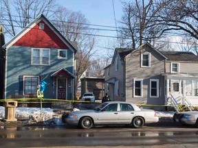 A makeshift memorial pays tribute to a 19-year-old black man killed by police, as an officer guards the 1100 block of Williamson Street in Madison, Wisconsin March 7, 2015. REUTERS/Tom Lynn