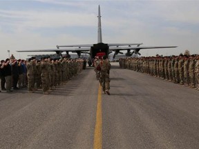 Ramp ceremony held by the Canadian Special Operations Regiment (CSOR) and coalition soldiers for Sergeant Andrew Joseph Doiron at Erbil International Airport, Iraq, on March 8, 2015. (NATIONAL DEFENCE CANADA)
