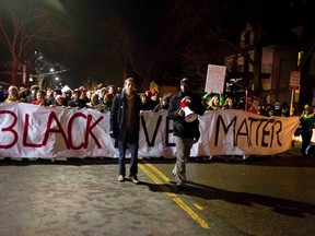 Protesters march down Williamson Street after a candlelight vigil on Sunday night for Tony Robinson, Jr. In Madison Wisconsin March 8, 2015. (REUTERS/Ben Brewer)