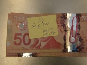 London police are appealing to the public to help find the owner of a box containing more than $10,000 found on the shelf of a northeast store. (Photo supplied by police)