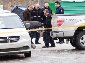 A body is removed from the scene as police continue to investigate a suspicious death near 118 Avenue and 125 Street, in Edmonton Alta., on Monday March 9, 2015. David Bloom/Edmonton Sun