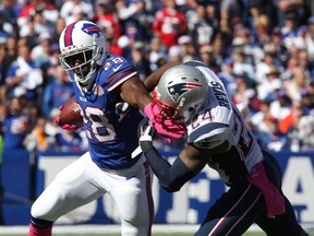 Buffalo Bills running back C.J. Spiller (28) runs the ball while New England Patriots cornerback Darrelle Revis (24) tries to make a tackle during the first half at Ralph Wilson Stadium. (Timothy T. Ludwig-USA TODAY Sports)
