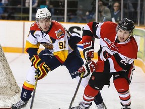 Connor McDavid of the Erie Otters checks Ottawa 67's Evan de Haan during OHL at TD Place arena Feb. 1, 2015. It was one of the few high-attendance games for the 67's this season.(Errol McGihon/Ottawa Sun/QMI Agency)