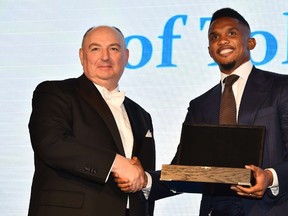 Cameroonian footballer Samuel Eto'o is presented with the Medal of Tolerance by President of the European Council on Tolerance and Reconciliation (ECTR), Moshe Kantor at a gala in London. (BEN STANSALL/AFP)