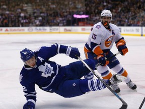 The Isles’ Cal Clutterbuck knocks down Leafs centre Tyler Bozak on Monday night at the ACC. MICHAEL PEAKE/TORONTO SUN)