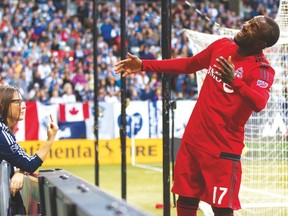 Whitecaps fan Kirsty Olychick gives TFC’s Jozy Altidore the finger during Saturday’s game in Vancouver. Altidore says he loves the photo which caused an online sensation. (Duncan Nicol/Vancouver Southsiders)