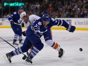 Maple Leafs defenceman Morgan Rielly intently watches the puck on March 9, 2015 during a game against the New York Islanders ... but fewer people are watching him and his team on television. (MICHAEL PEAKE/Toronto Sun)