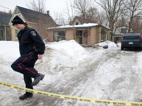 Police are investigating a slaying at 504 English St. Witnesses say three men, two black and one white, all wearing hoodies, ran from the house. (CRAIG GLOVER, The London Free Press)