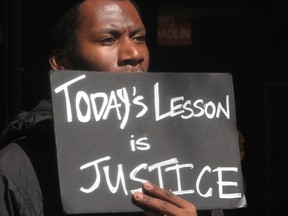 A student holds a sign at a rally at the state Capitol in Madison, Wisconsin, March 9, 2015. (REUTERS/Brendan O'Brien)