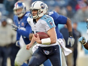 Tennessee Titans quarterback Jake Locker (10) runs with the ball against the New York Giants during the second half at LP Field. The Giants beat the Titans 36-7. (Don McPeak-USA TODAY Sports)