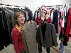 Carol Roberts, left, of the KEYS Job Centre and Lindsay MacDonald of Dressed For Success Kingston are preparing for the Suit Up event on Wednesday. Professional clothes will be offered for free to job seeking men and women. (Ian MacAlpine/The Whig-Standard)