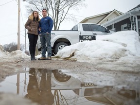 Anthony Franze and fiancee Debra Robarts stand at the spot where he discovered a crying baby on Emery St. E. (Free Press file photo)