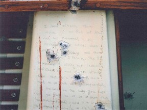 A blood-stained message that prosecutors say Boston Marathon bombing suspect Dzhokhar Tsarnaev wrote on the inside of a boat is seen with bullet holes in an undated evidence picture shown to jurors in Boston March 10, 2015. (REUTERS/U.S. Department of Justice/Handout via Reuters)