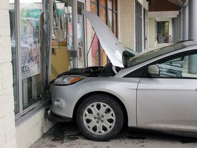 A silver Ford Focus after having driven into the Kingston Community Credit Union in Kingston, Ont. on Tuesday March 10, 2015. No injuries were reported. Steph Crosier/Kingston Whig-Standard/QMI Agency