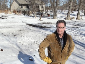 Brian Wolfe stands on the dike behind his home in St. Francois Xavier, Man. Tuesday March 10, 2015. Wolfe is concerned that an increased water flow on the Assiniboine River will flood his property.