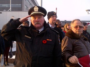 Toronto Fire District Chief Fred McKay salutes as the hearse bearing the casket of Sgt. Andrew Doiron arrives in Toronto Tuesday, March 11, 2015. (Joe Warmington/Toronto Sun)