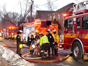 Emergency crews work on a victim after a fire on Winona Dr. Tuesday, March 10, 2015. (Pascal Marchand photo)