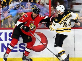 Ottawa Senators Marc Methot holds up Boston Bruins Dennis Seidenberg during NHL hockey action at the Canadian Tire Centre on Tuesday March 10, 2015. 
Errol McGihon/Ottawa Sun/QMI Agency