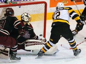 Kingston Frontenacs defenceman Evan McEneny scores against Petes goalie Matthew Mancina as Josh Maguire skates in during first-period Ontario Hockey League action in Peterborough on Tuesday night. The Frontenacs won 6-2. (Clifford Skarstedt/QMI Agency)