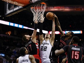 Spurs power forward Tiago Splitter gets blocked by Raptors forward Terrence Ross (right) in San Antonio last night. (USA TODAY)