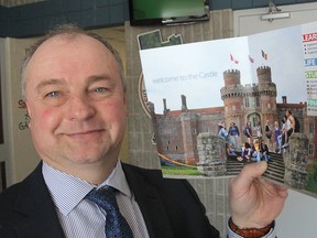 Shawn Lehman, with the Limestone District School Board, holds a pamphlet promoting Queen's Herstmonceux Castle in England. High school students will now have the chance to study there. (Michael Lea/The Whig-Standard)
