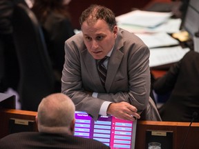 Councillor Josh Colle talks with Councillor Rob Ford during budget debate in Toronto Wednesday, March 11, 2015. (Craig Robertson/Toronto Sun)